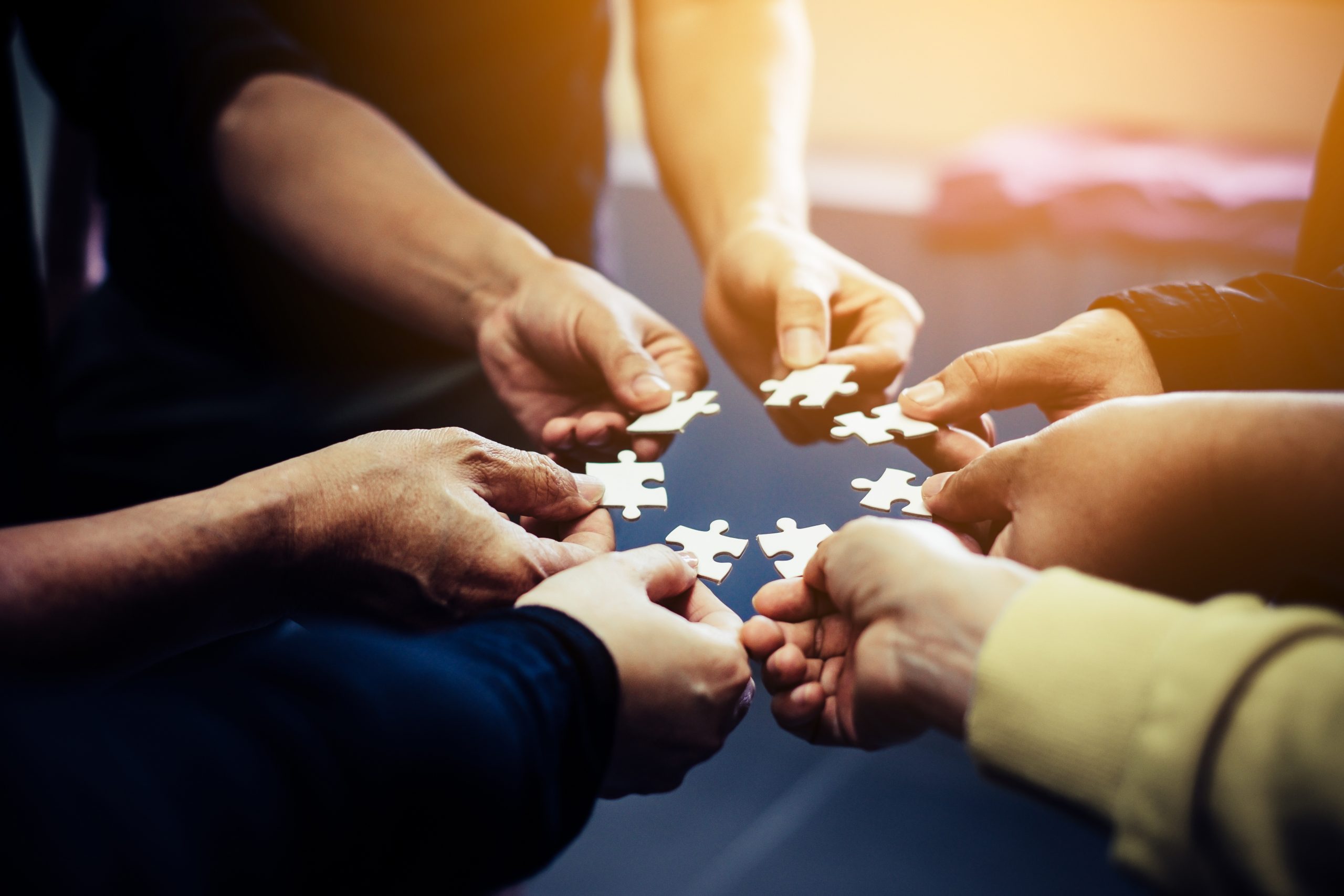 Close-up,Photo,Of,Businesspeople,Holding,Jigsaw,Puzzle