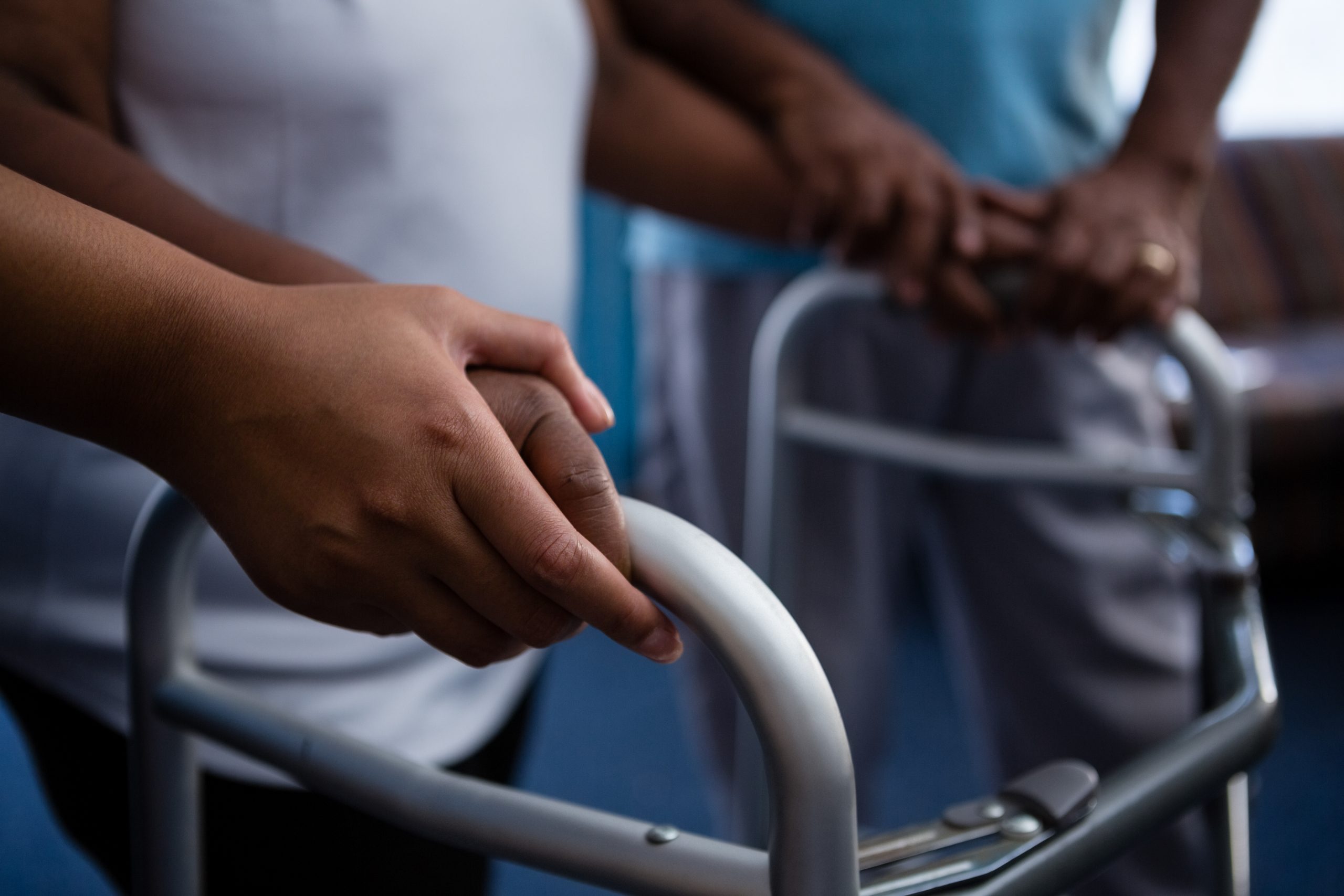 Cropped,Hands,Of,Nurse,Assisting,Woman,In,Walking,With,Walker