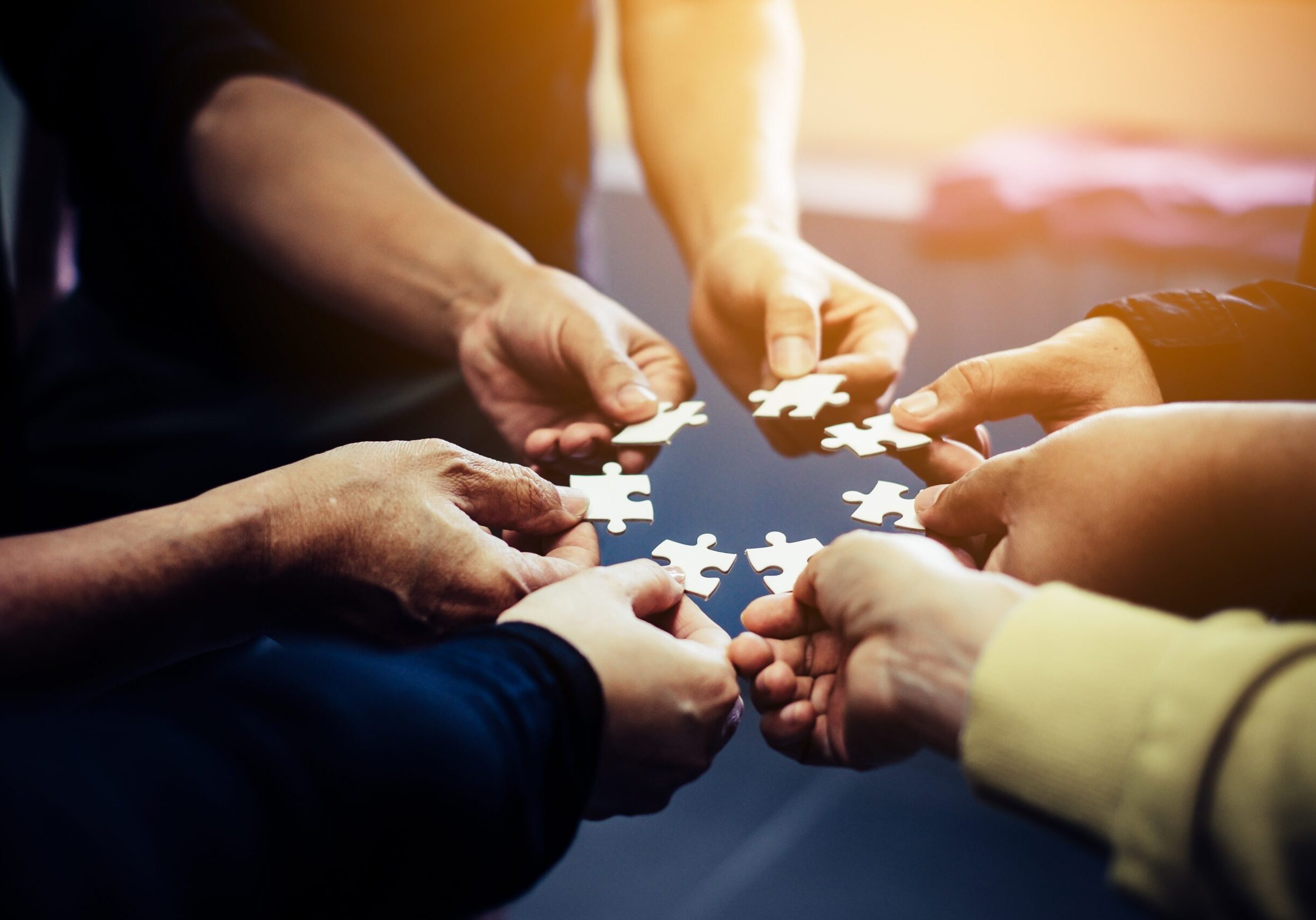 Close-up,Photo,Of,Businesspeople,Holding,Jigsaw,Puzzle