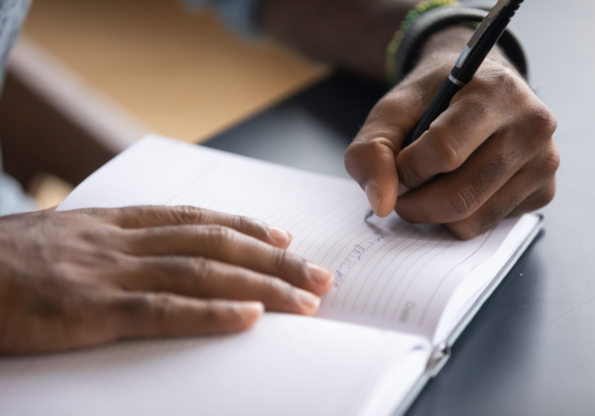 African,Man,Sit,At,Desk,Hold,Pen,Keeps,Startup,Business